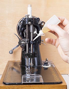 oiling an antique sewing machine